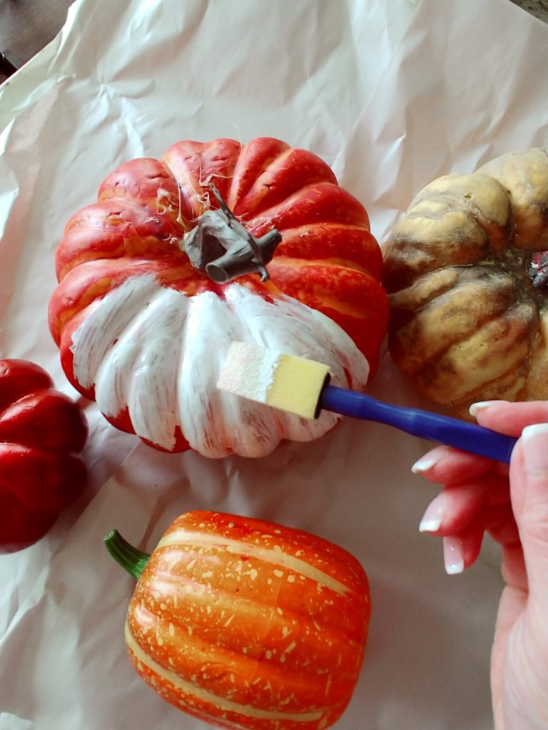 painting orange pumpkins white