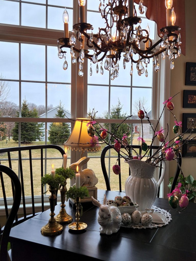 A room filled with furniture and vase of flowers on a table