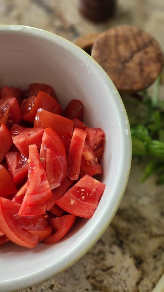 cut up fresh tomatoes in bowl 