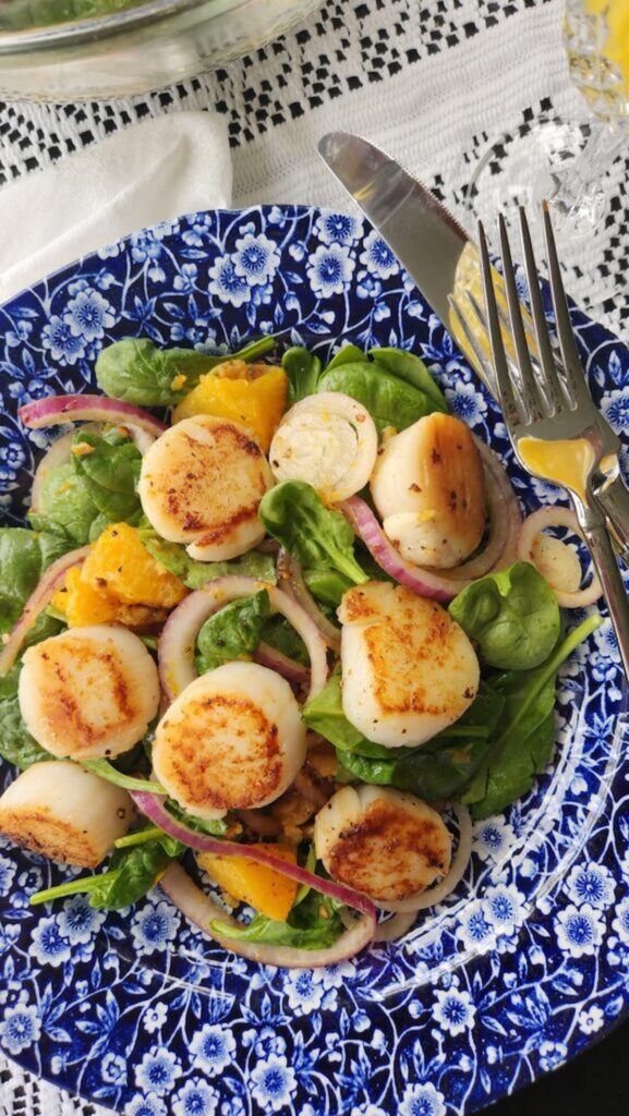 scallop salad on blue and white dish