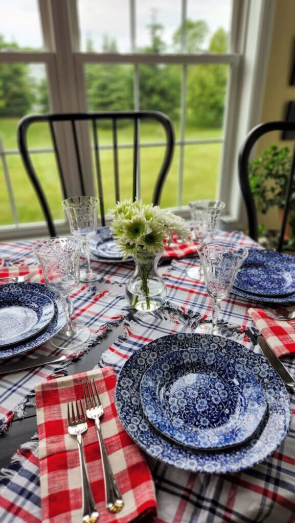 red white and blue table with white daisy's in middle of table