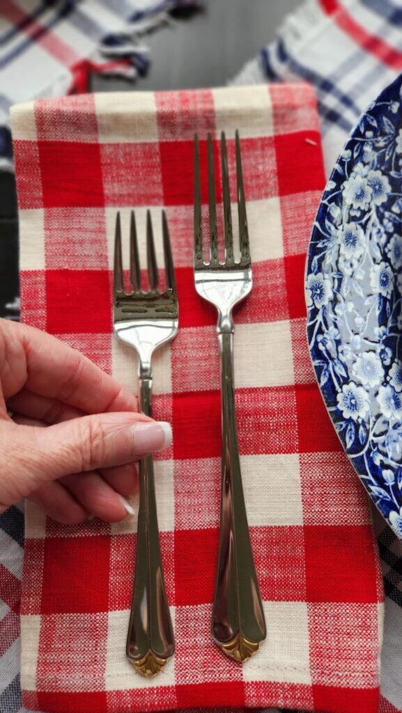 red and white checked napkins with silverware on top