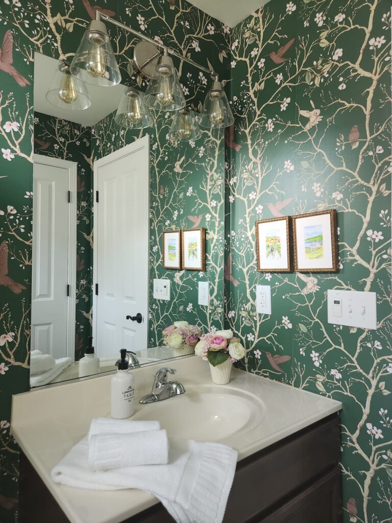 lighting in a wallpapered bathroom