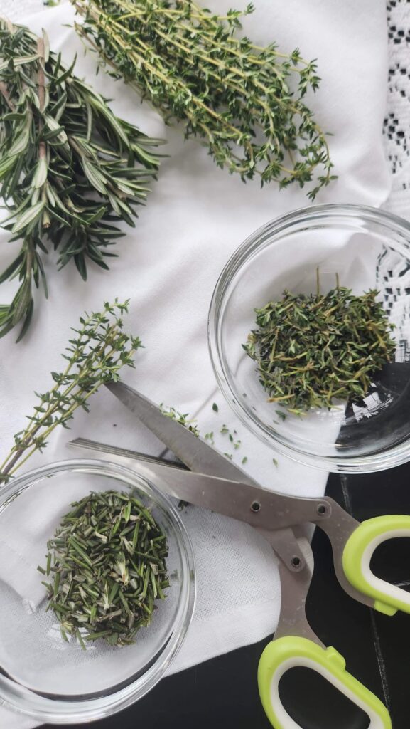 fresh herbs on table cloth in glass bowls