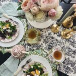 overhead photo of table with pink flowers and salad