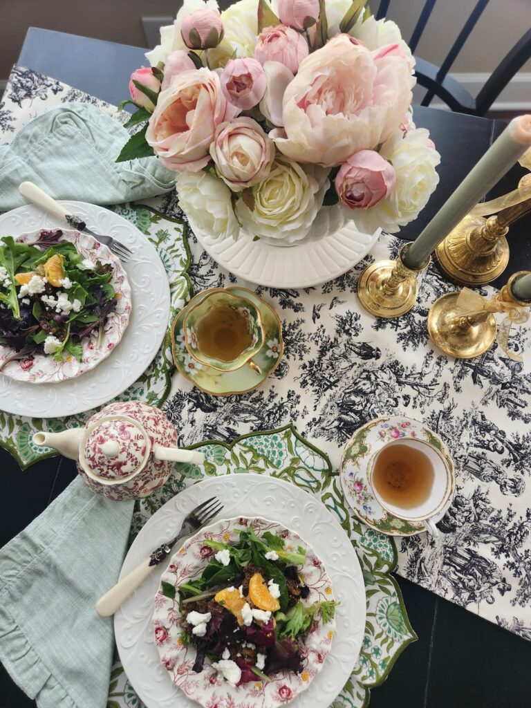 overhead photo of table with pink flowers and salad