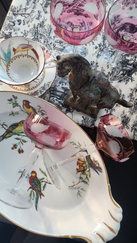 Pink vintage champagne glasses, bird tea cup and french vegetable dish