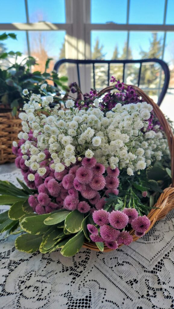 fresh purple and white flowers in a basket